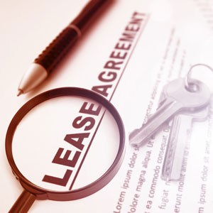 A lease agreement with keys and a magnifying glass - Big Catch Consulting